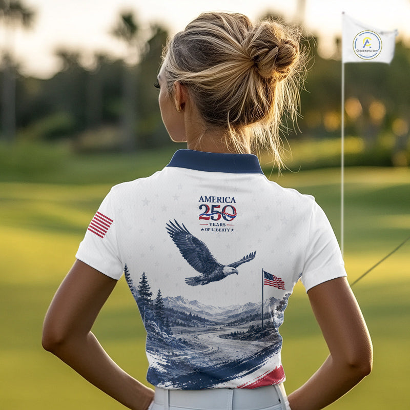 Woman on a golf course wearing a polo shirt with an eagle design and text.