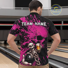 Load image into Gallery viewer, Person wearing a black and pink bowling shirt with a skeleton design at a bowling alley.