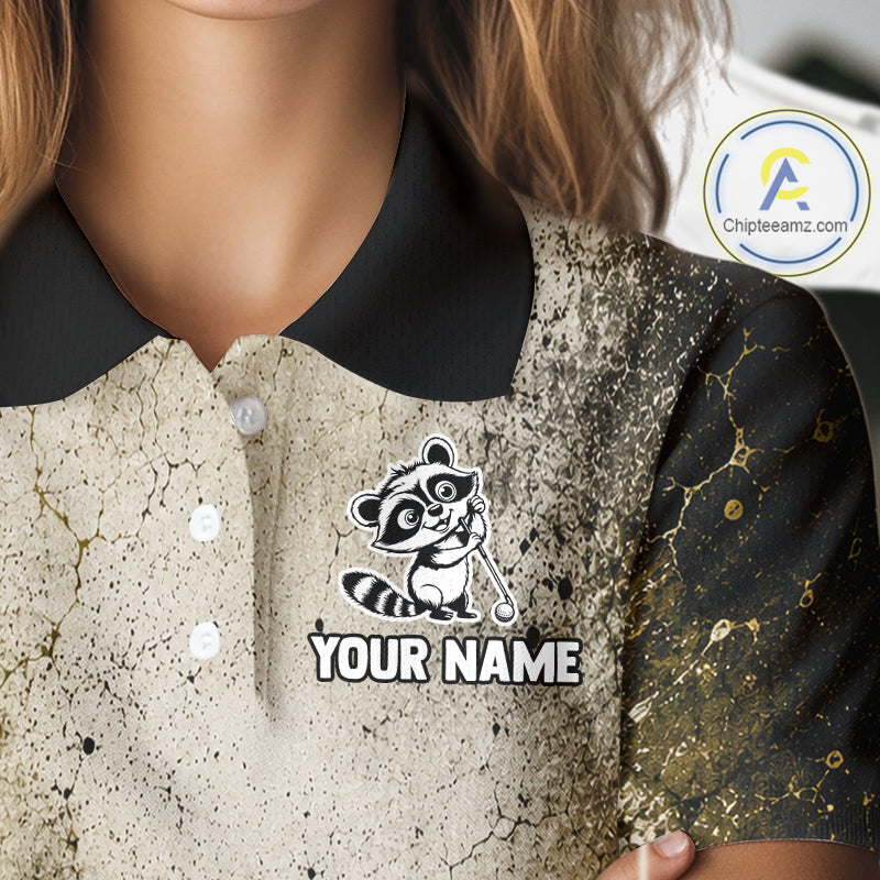 Close-up of a polo shirt with a raccoon logo and 'Your Name' text on a textured background.