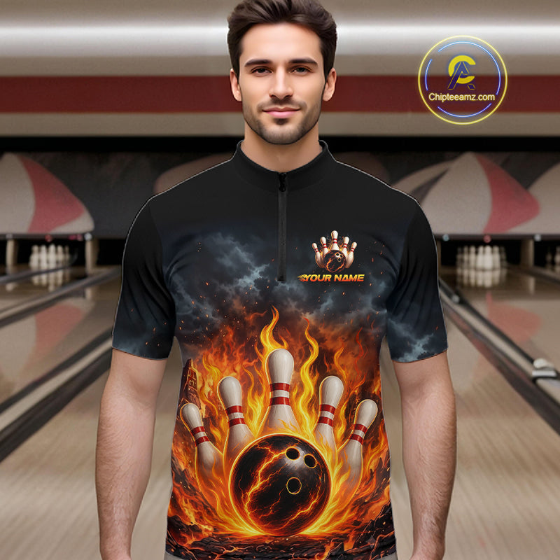 A man wearing a black short-sleeve zip-front shirt with a bold bowling-themed graphic print featuring a flaming bowling ball, bowling pins, and smoke. The shirt has a placeholder chest graphic reading 'YOUR NAME'.