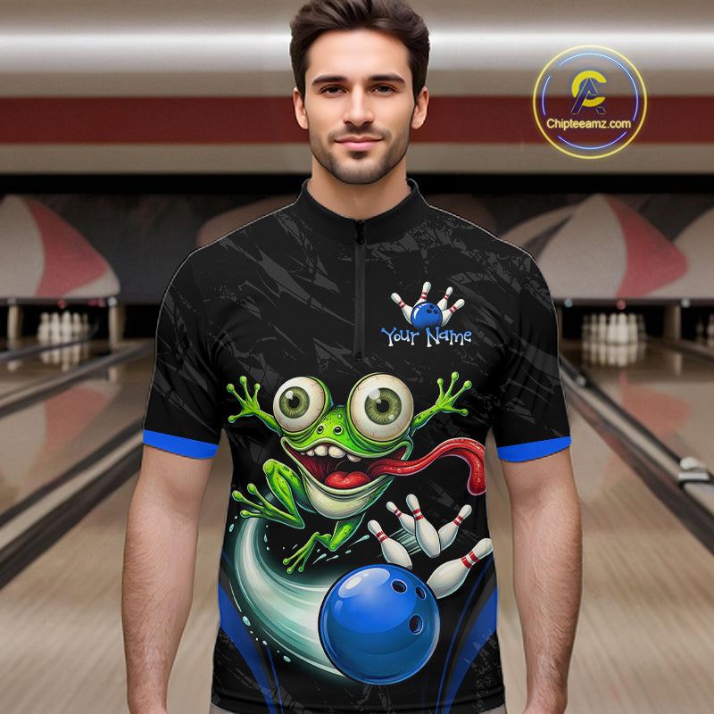 A man wearing a black short-sleeve cycling jersey with a colorful graphic of a green cartoon frog, bowling pins, and a blue bowling ball. The jersey has blue trim on the collar and cuffs, and the background shows a blurred bowling alley scene.