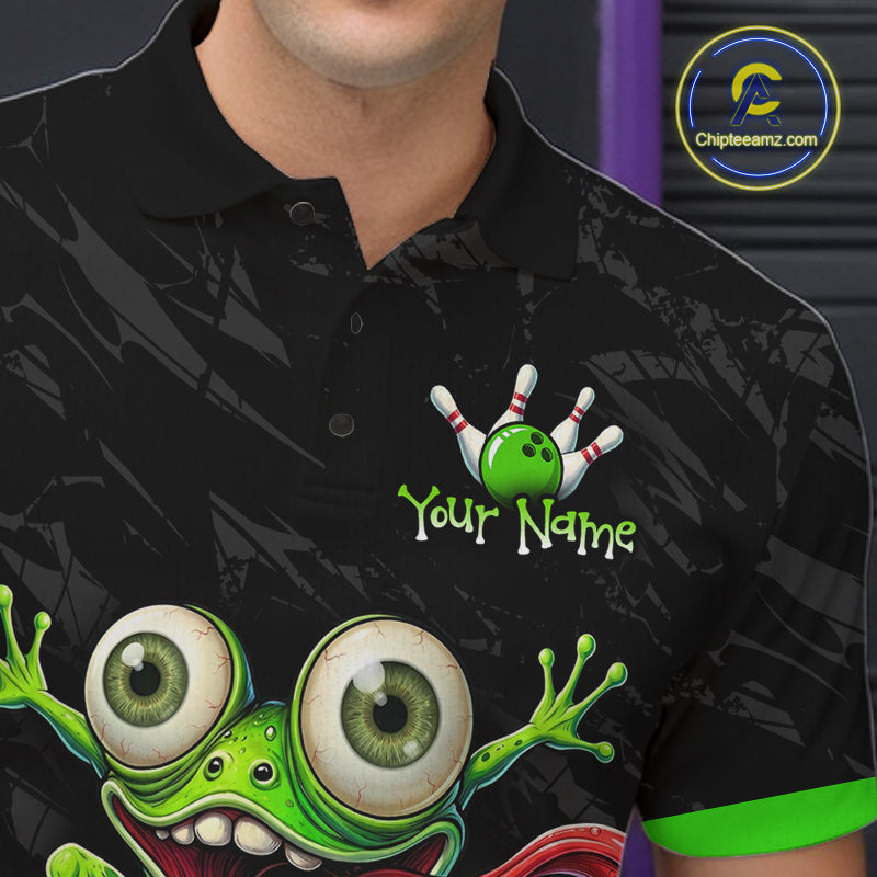A close-up of a person wearing a black short-sleeve polo shirt with a colorful bowling-themed graphic on the chest, including a green bowling ball, white pins, and a cartoon frog. The shirt has a custom text placeholder reading 'Your Name' and a visible Chipteeamz.