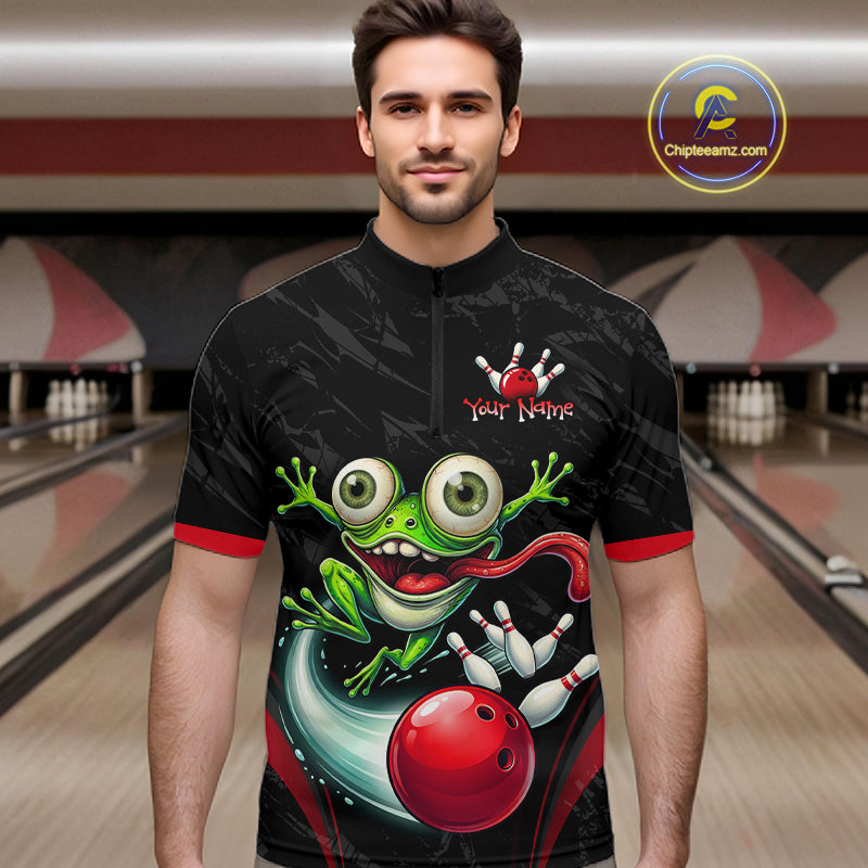 A man wearing a black short-sleeve cycling jersey with a colorful graphic of a green cartoon frog, a red bowling ball, and bowling pins. The jersey has red trim on the collar and cuffs, and a mock zip at the neck.