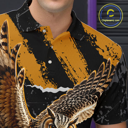 A close-up of a person wearing a short-sleeve button-up shirt with a bold graphic print. The shirt features a black and mustard yellow abstract background with a large detailed owl wing and face in brown, black, and white across the lower portion.