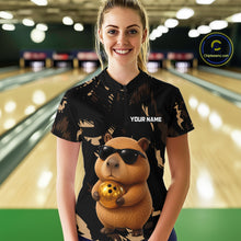 Load image into Gallery viewer, Person wearing a bowling shirt with a capybara design and 'Your Name' text in a bowling alley.