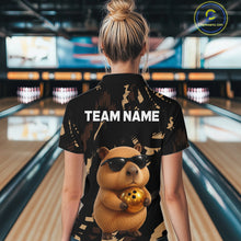 Load image into Gallery viewer, Person wearing a black shirt with a capybara graphic and 'TEAM NAME' text in a bowling alley.