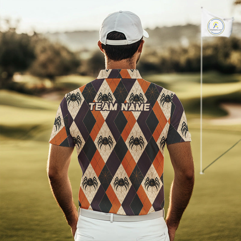 A man viewed from behind on a golf course, wearing a short-sleeve collared polo shirt with an orange, cream, and dark gray argyle pattern featuring spider graphics and the text 'TEAM NAME' across the upper back. He is also wearing a white cap and white pants.