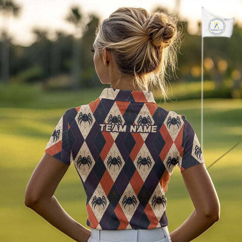 A woman viewed from behind on a golf course, wearing a short-sleeve collared polo shirt with a navy, rust orange, and beige harlequin pattern decorated with black spiders and the text 'TEAM NAME' on the back.