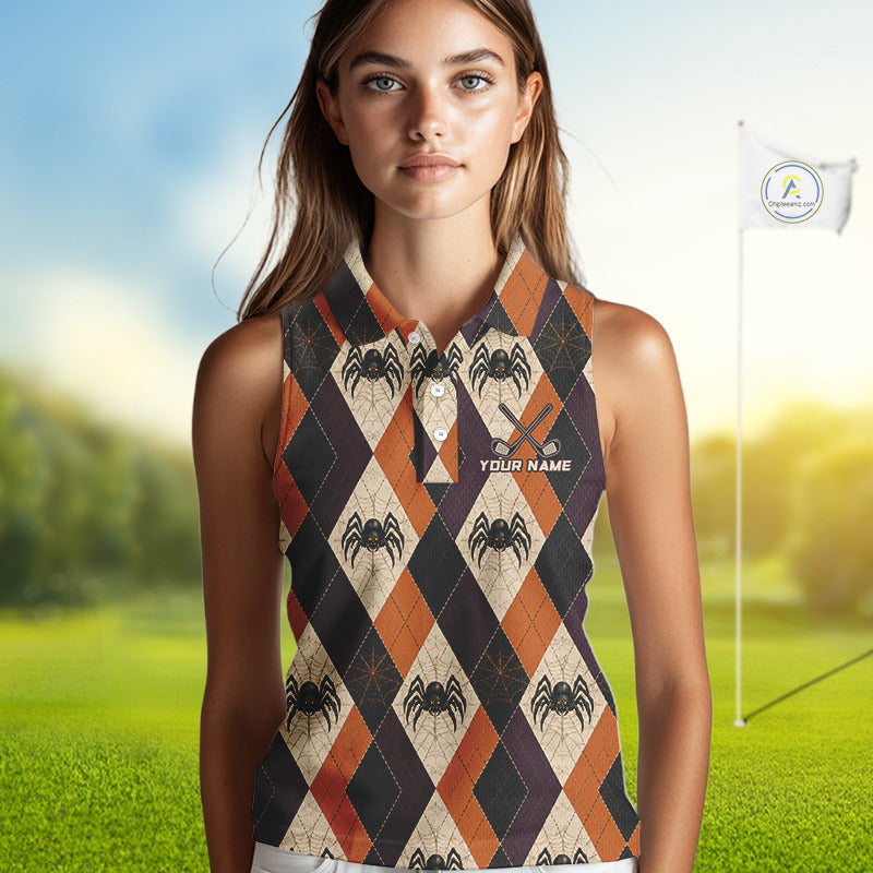 A woman stands on a golf course wearing a sleeveless collared top with an argyle spider pattern in orange, black, beige, and dark purple. The top has a small white text print that reads 'YOUR NAME'.