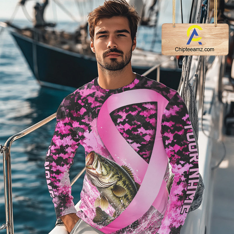 Angler wearing pink ribbon camouflage bass fishing breast cancer long sleeve sun protection shirt on the water