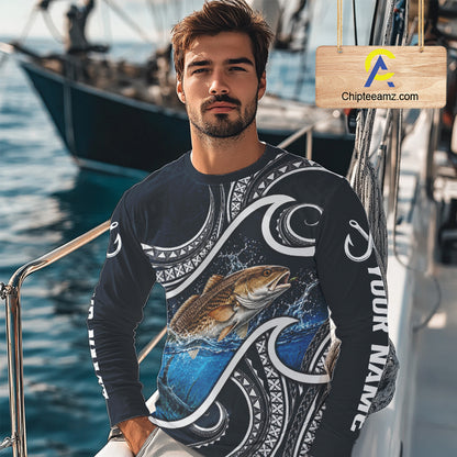 Angler wearing blue tribal pattern custom redfish long sleeve fishing shirt on the water