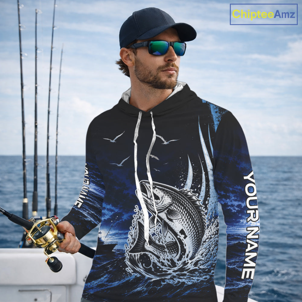 Angler wearing personalized Redfish Red Drum blue long sleeve hooded performance fishing shirt on the water