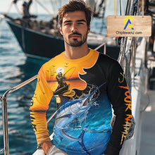 Load image into Gallery viewer, Man wearing a colorful marlin fishing-themed shirt on a boat