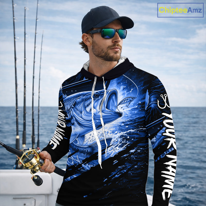 Man wearing a long sleeve hooded fishing shirt with a blue bass fish design on a boat