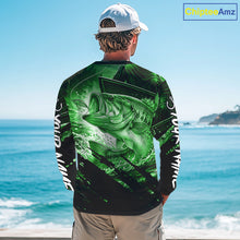 Load image into Gallery viewer, Person wearing a green and black bass fishing shirt with a fish design, standing by the ocean.