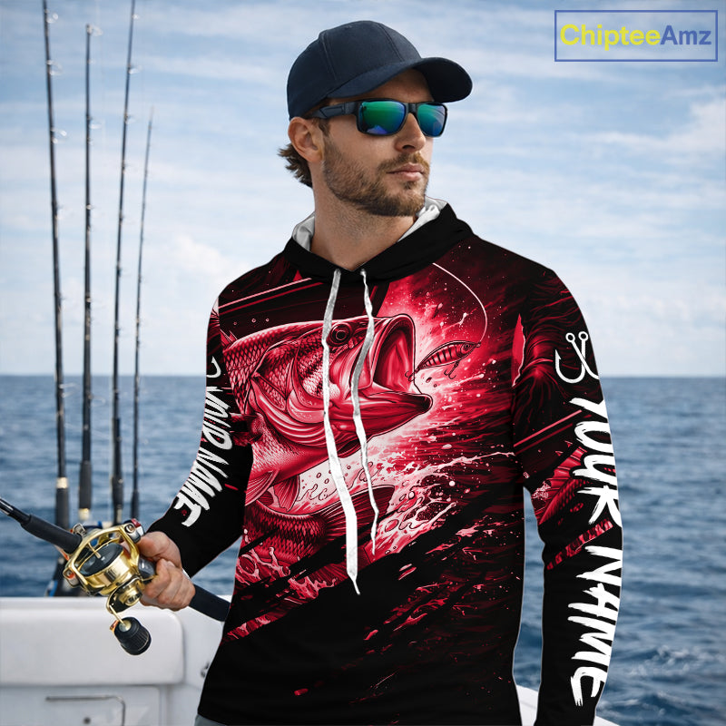 Man wearing a long sleeve hooded fishing shirt with a red bass fish design on a boat