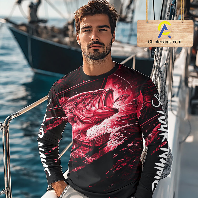 Man wearing a long sleeve fishing shirt with a red bass fish design on a boat