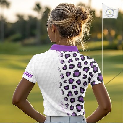 Woman on a golf course wearing a white polo shirt with purple leopard print
