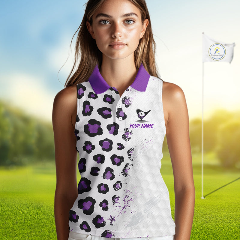 Woman wearing a white sleeveless golf shirt with purple leopard print on a golf course.