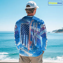 Load image into Gallery viewer, Man on a boat wearing a blue American flag redfish fishing shirt long sleeve with custom name on the sleeves