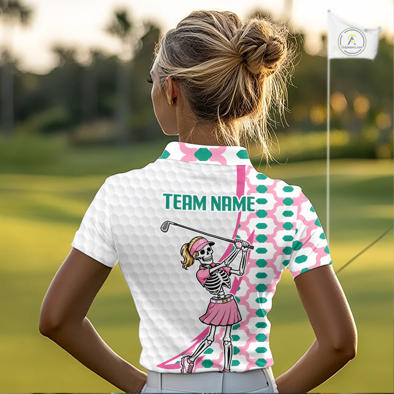 Person wearing a white polo shirt with a skeleton golfer design on a golf course