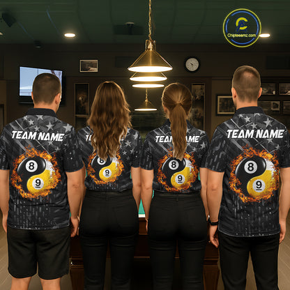 Group of men and women wearing matching black billiard team polo shirts with distressed silver star patterns, personalized "Your Name" details, and 8-ball & 9-ball graphics, posing together beside a pool table in a billiards hall.
