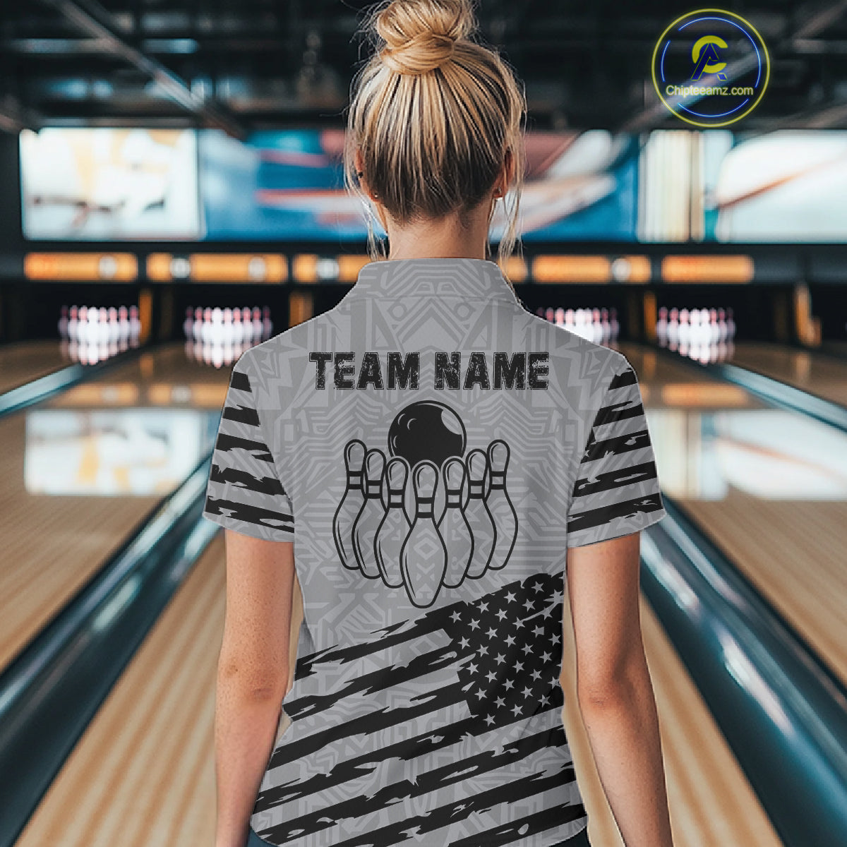 Woman wearing a grey American flag bowling quarter zip jersey during tournament play back view.