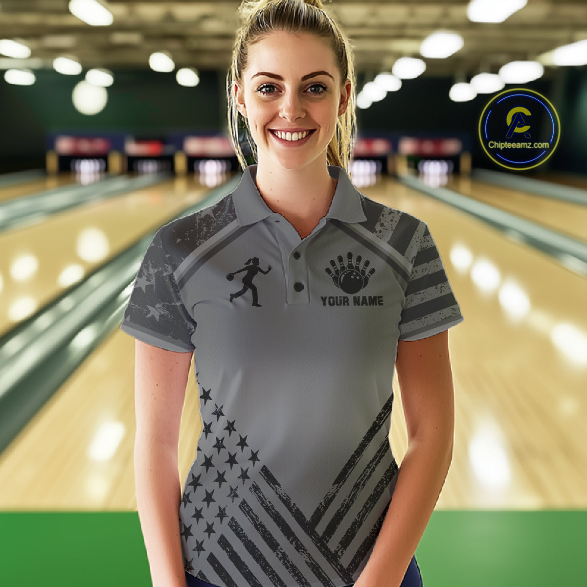 Woman wearing a grey American flag bowling polo shirt at a bowling alley front view.