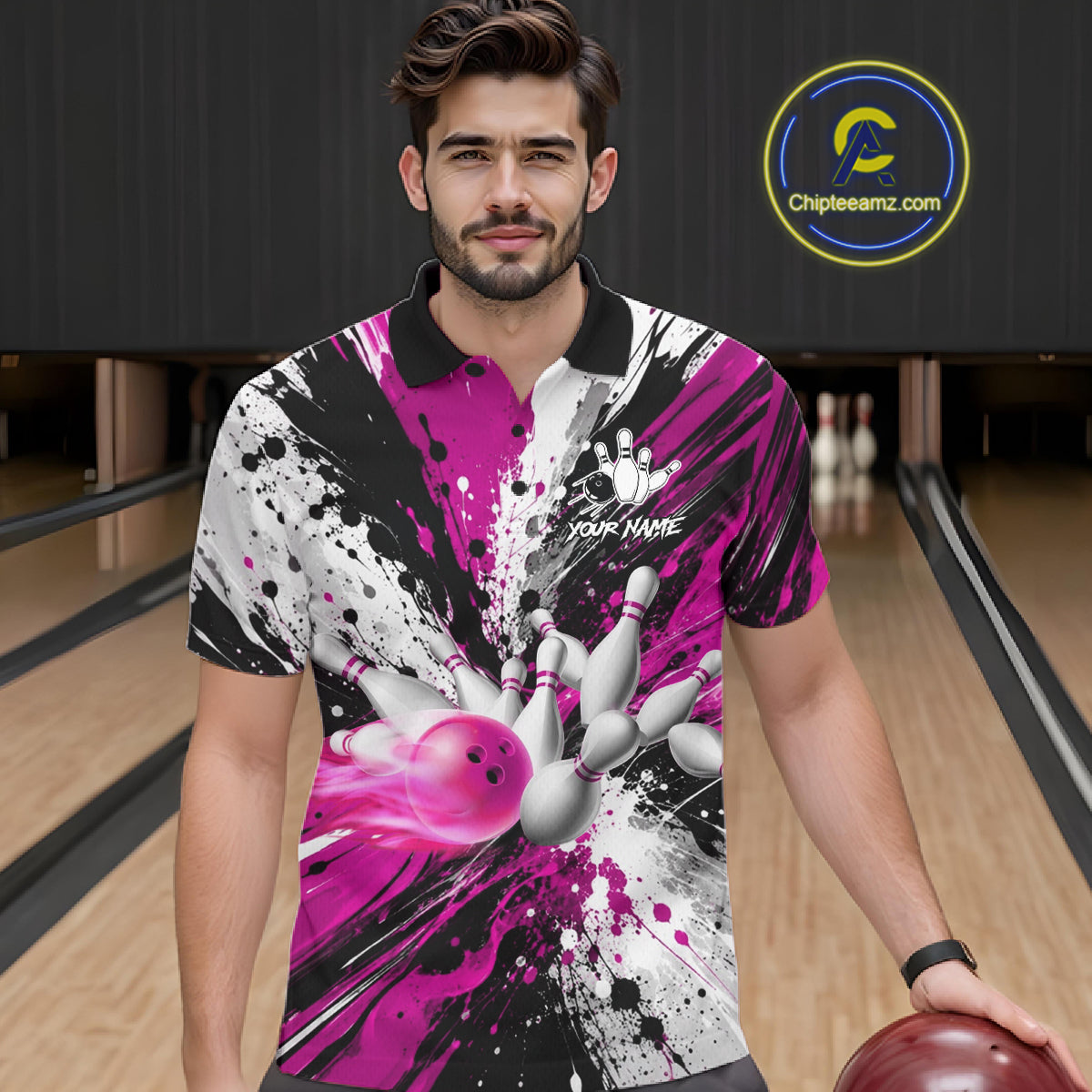 Man wearing a pink splatter bowling polo shirt at a bowling alley front view.