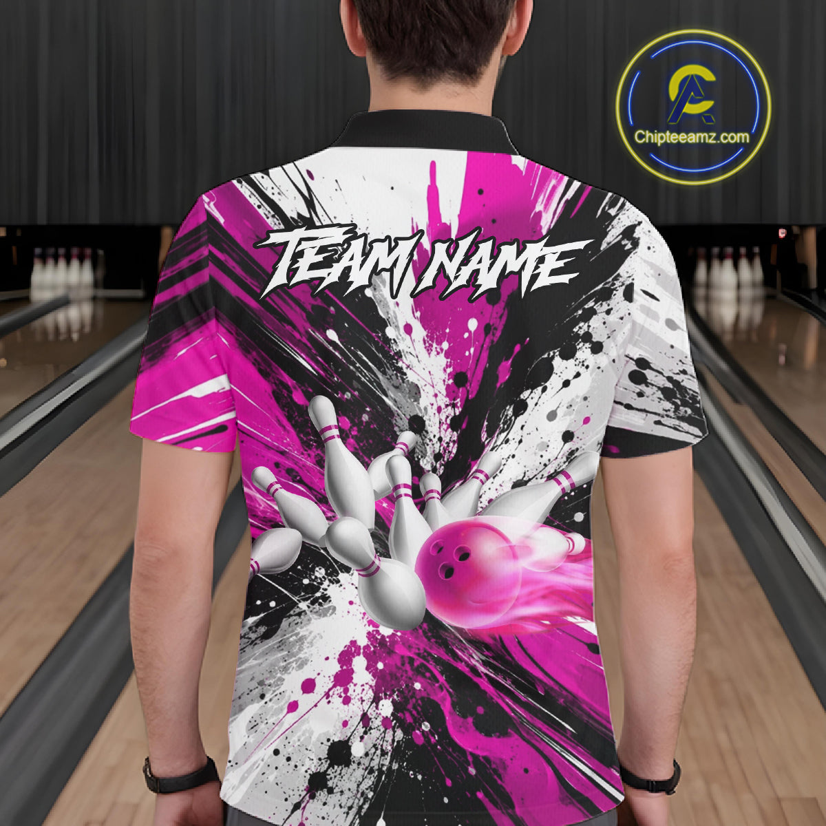 Back view of man wearing a pink splatter bowling polo shirt inside a bowling alley.