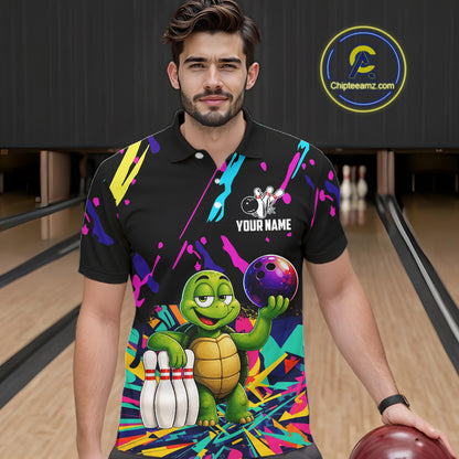 Man wearing a colorful bowling-themed shirt with a turtle graphic in a bowling alley.