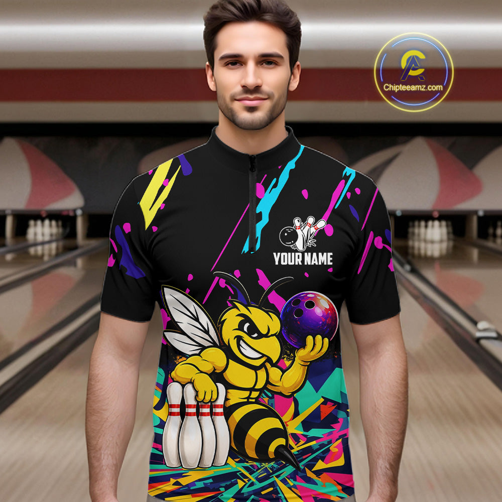 Man wearing a colorful bowling shirt with a bee graphic in a bowling alley.