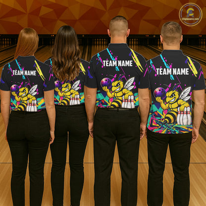 Four people wearing matching shirts with a bee graphic and 'TEAM NAME' text on a bowling alley background.
