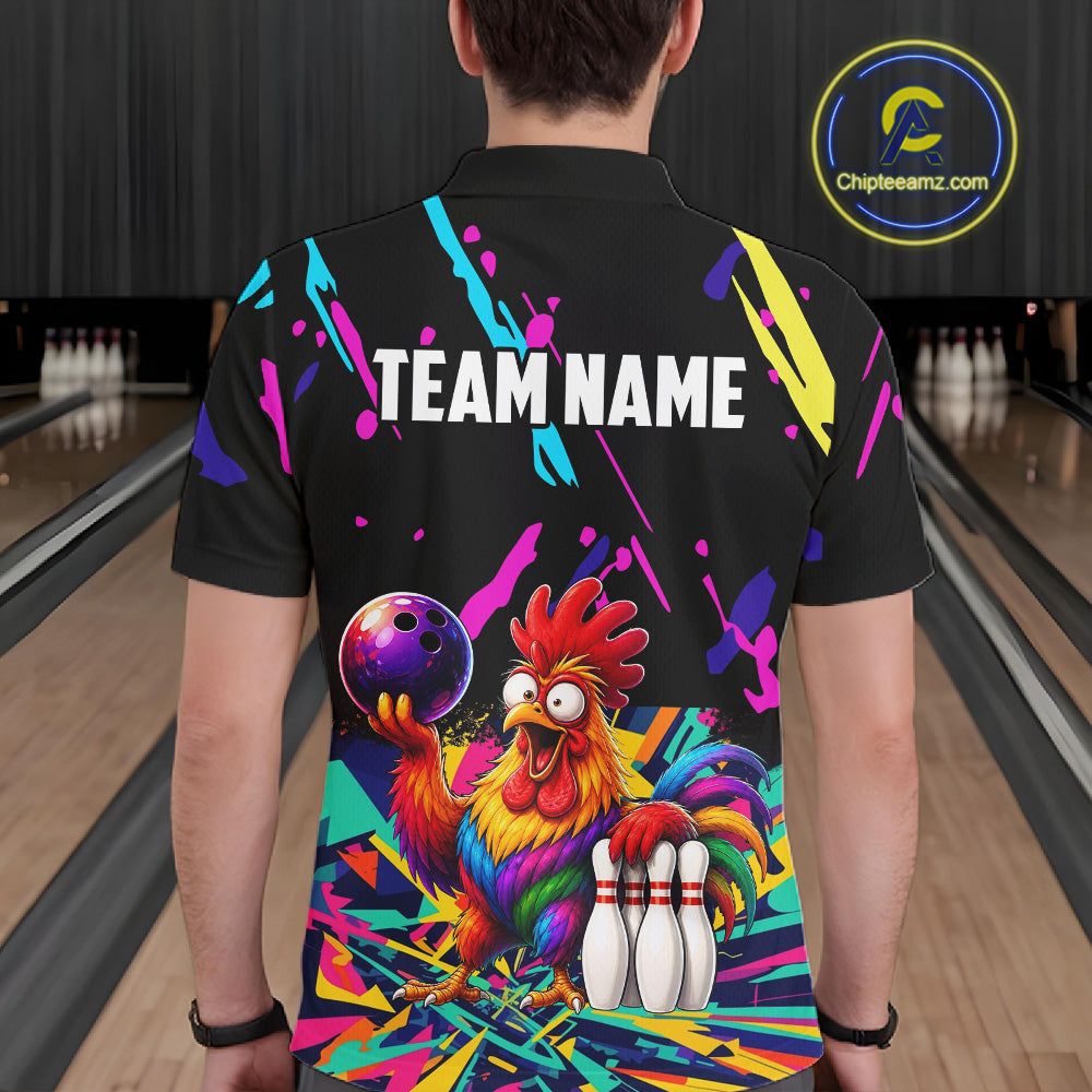 Person wearing a black bowling shirt with colorful design and  chicken graphic in a bowling alley.
