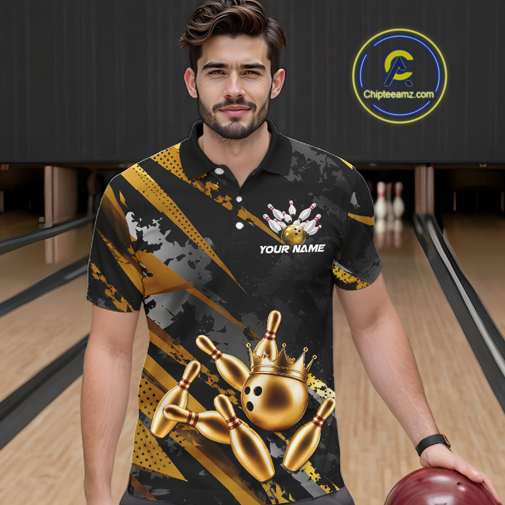 Man wearing a black and gold bowling shirt with a crown design on a bowling alley.