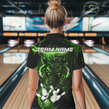Load image into Gallery viewer, Woman wearing green thunder lightning tiger bowling polo shirt back view.