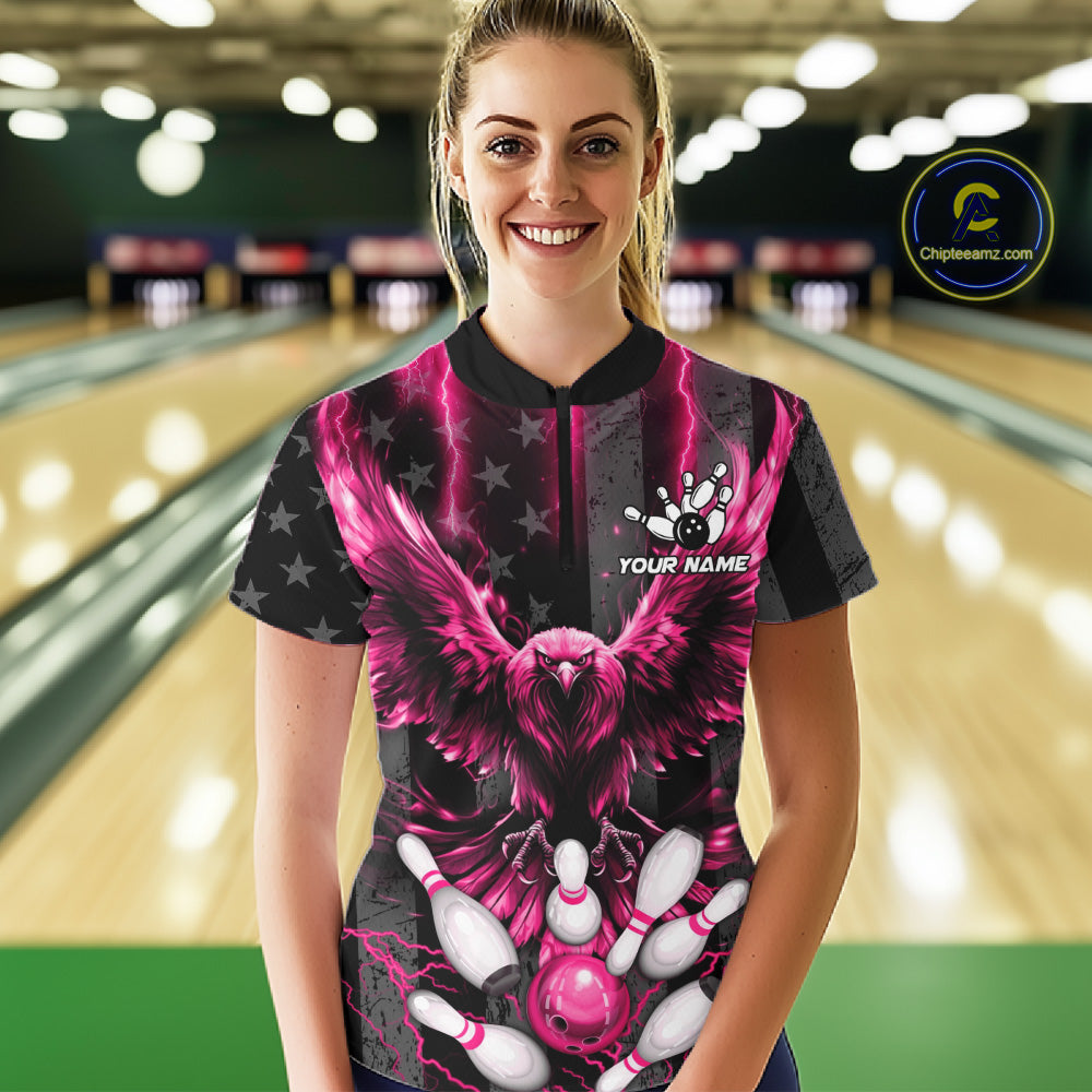 Front view of woman wearing a pink lightning eagle bowling polo shirt inside a bowling alley.