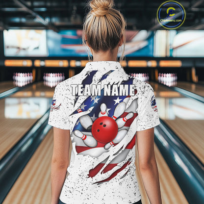 Back view of woman wearing a white grunge American flag eagle bowling polo shirt inside a bowling alley.