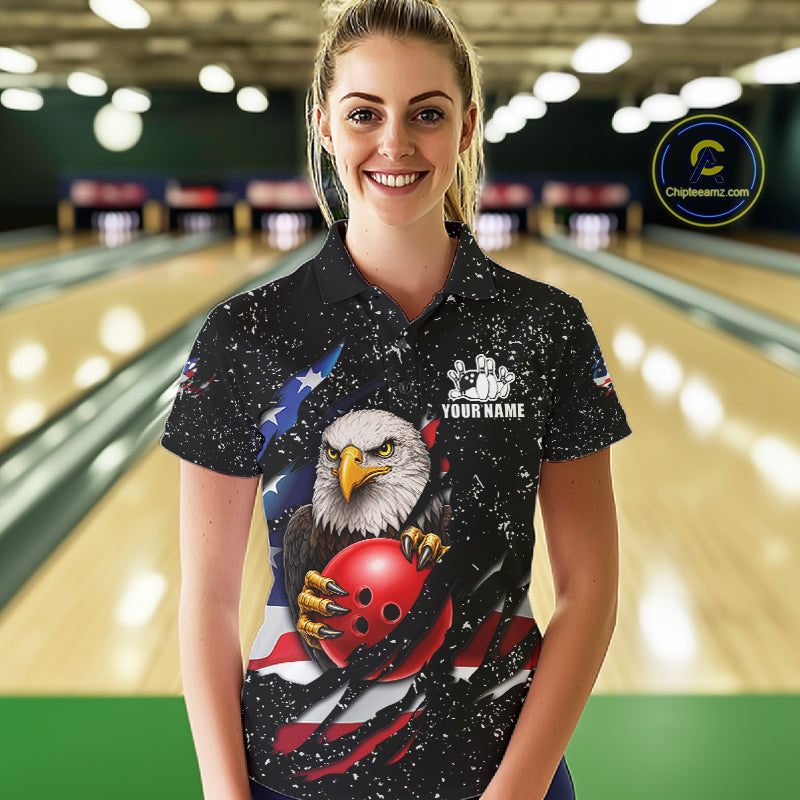 Woman wearing a black grunge American flag eagle bowling polo shirt at a bowling alley front view.