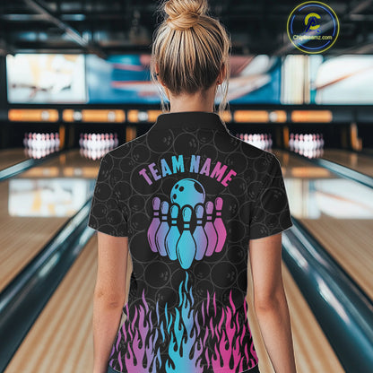Back view of woman wearing a fire flame neon bowling polo shirt inside a bowling alley.