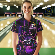 Load image into Gallery viewer, Woman wearing a funny purple neon raccoon bowling polo shirt at a bowling alley front view.