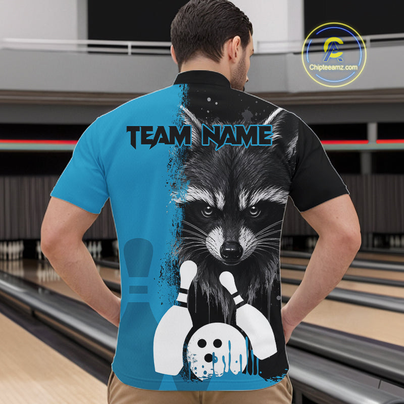 Back view of man wearing a black and blue raccoon bowling quarter zip shirt in a bowling alley.