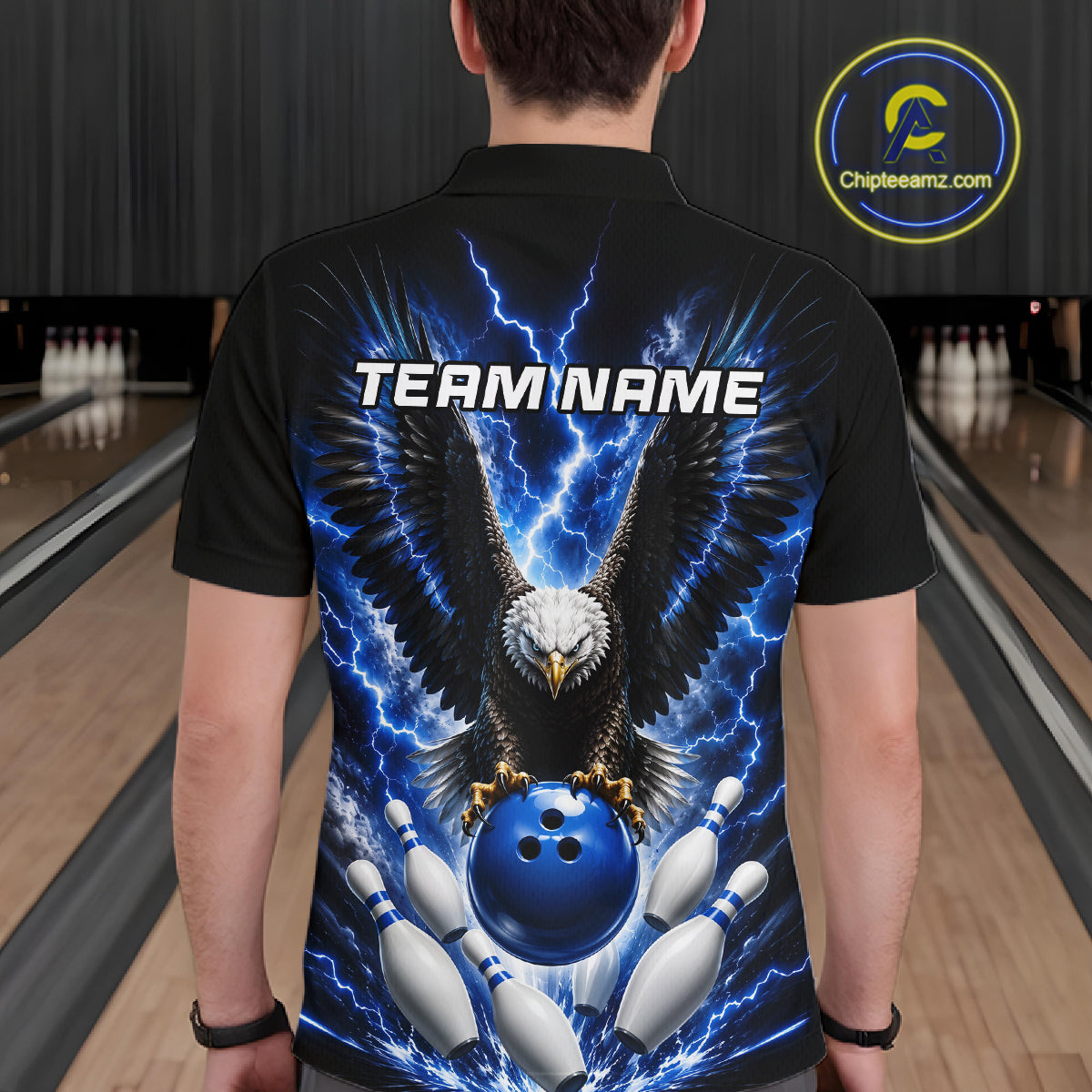 Back view of man wearing a blue thunder lightning eagle bowling polo shirt inside a bowling alley.