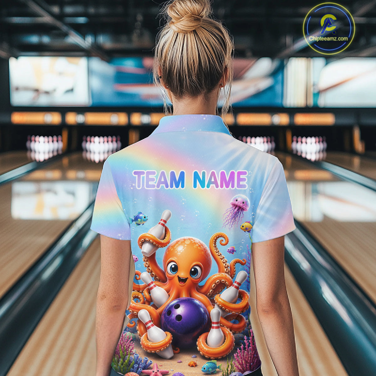 Back view of woman wearing a rainbow octopus ocean bowling polo shirt inside a bowling alley.