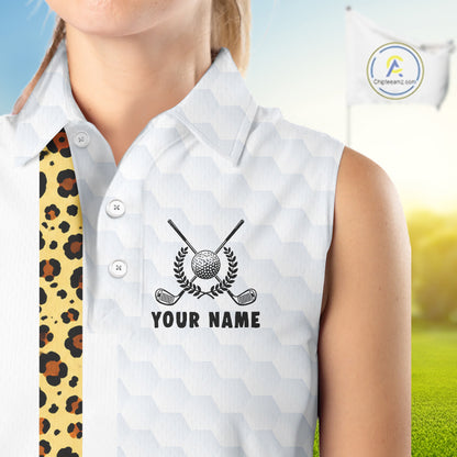 White sleeveless golf shirt with golf club and ball design, personalized with 'Your Name', on a blurred golf course background.