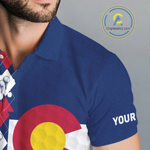 Load image into Gallery viewer, Male golfer wearing Colorado flag golf polo at scenic mountain golf course, perfect for golf vacations, outdoor adventure and state pride.
