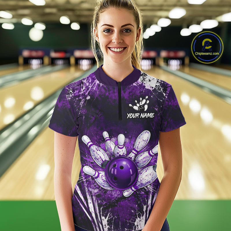 Person wearing a purple bowling shirt with a design and 'Your Name' text in a bowling alley.