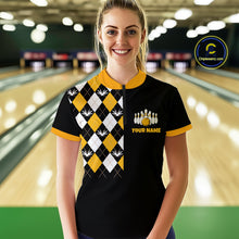 Load image into Gallery viewer, Woman wearing a black and yellow bowling shirt with a logo in a bowling alley.